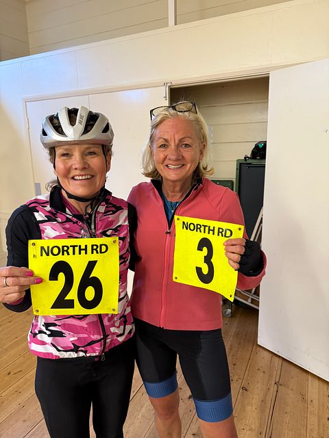 Photo of riders holding race numbers